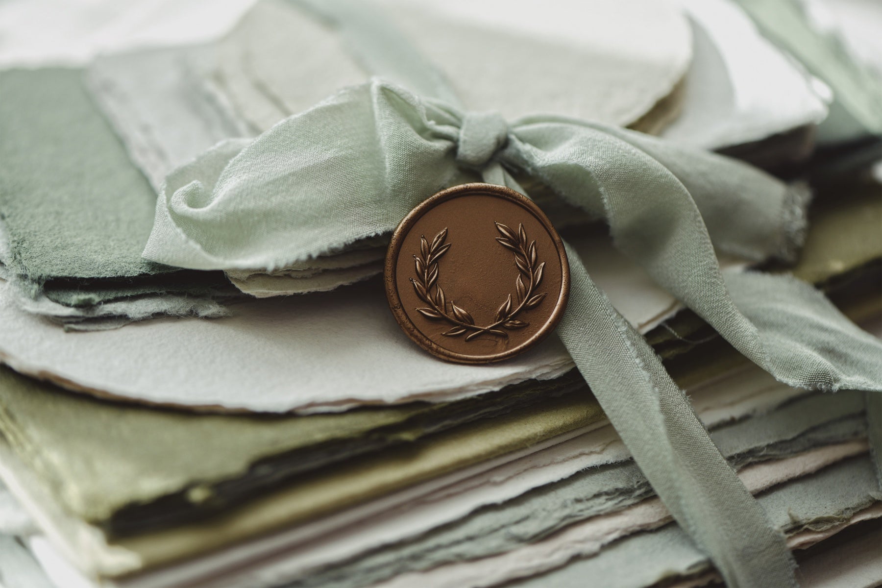 pelargon design olive antique gold wreath wax stamp green silk ribbon and cotton paper stack
